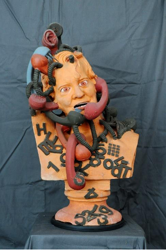 Photo of a colourful terracotta bust with telephone receivers wrapped around its head