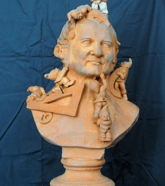 Photo of a terracotta bust populated with dwarves and measuring instruments