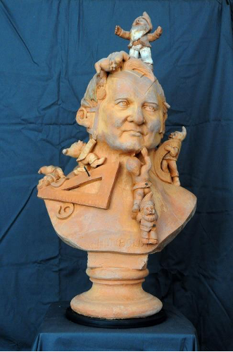 Photo of a terracotta bust populated with dwarves and measuring instruments